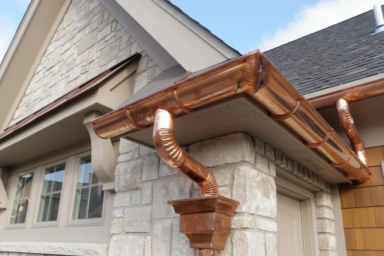 Copper gutters installed along a roof edge