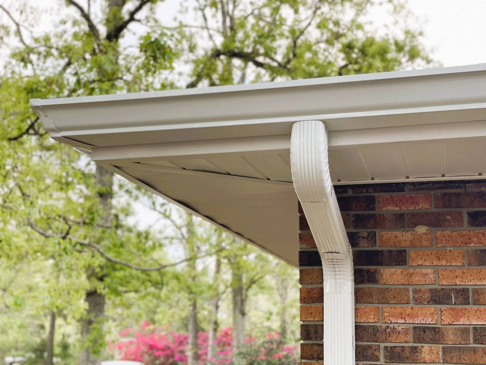 White seamless gutters on a stucco home